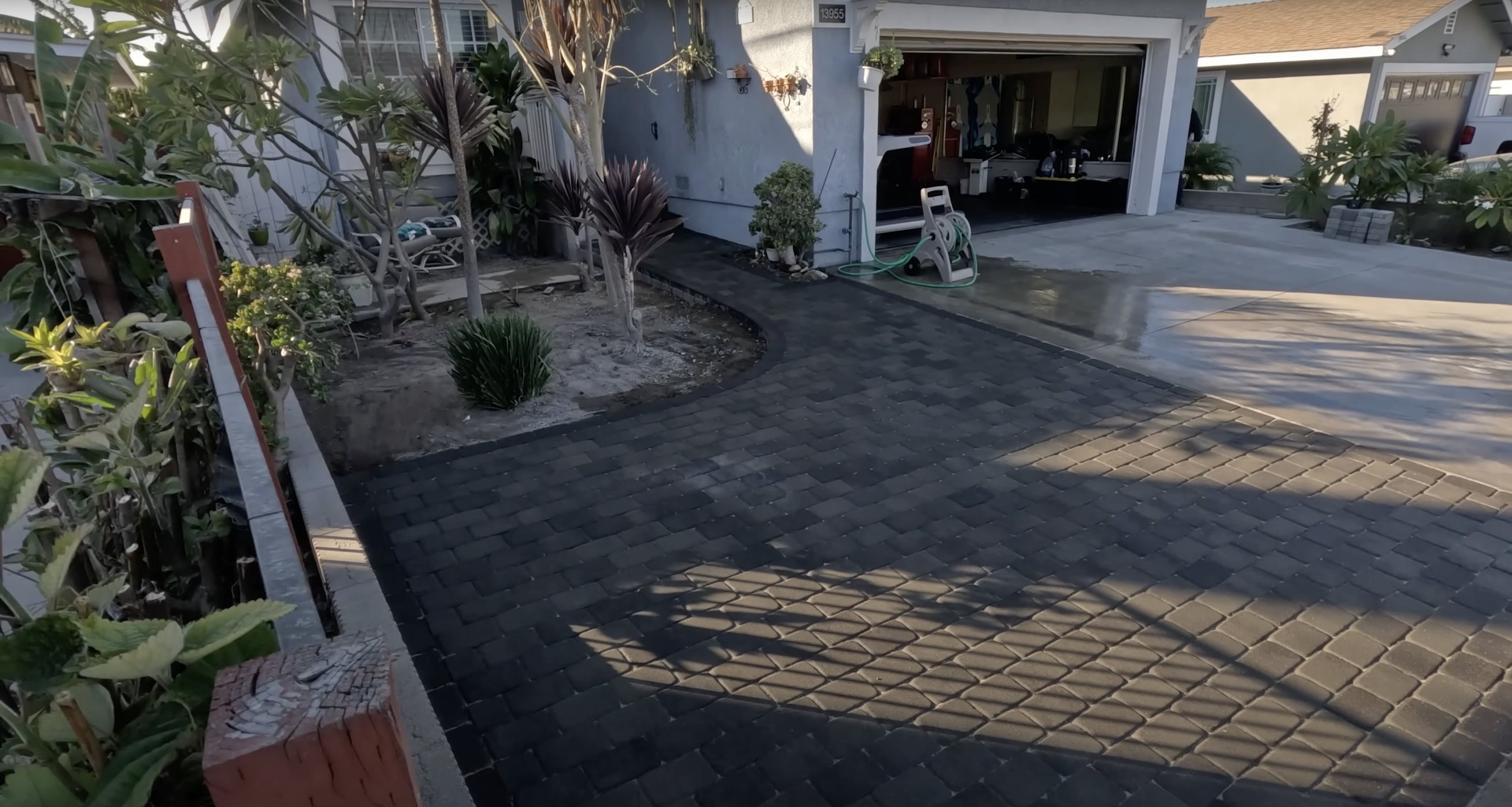 Residential concrete driveway with decorative paver accents