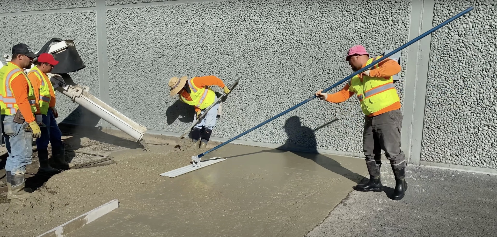 Commercial concrete construction team working with equipment