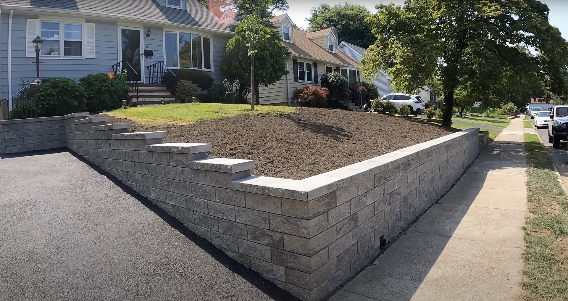 Finished concrete retaining wall and landscaping project