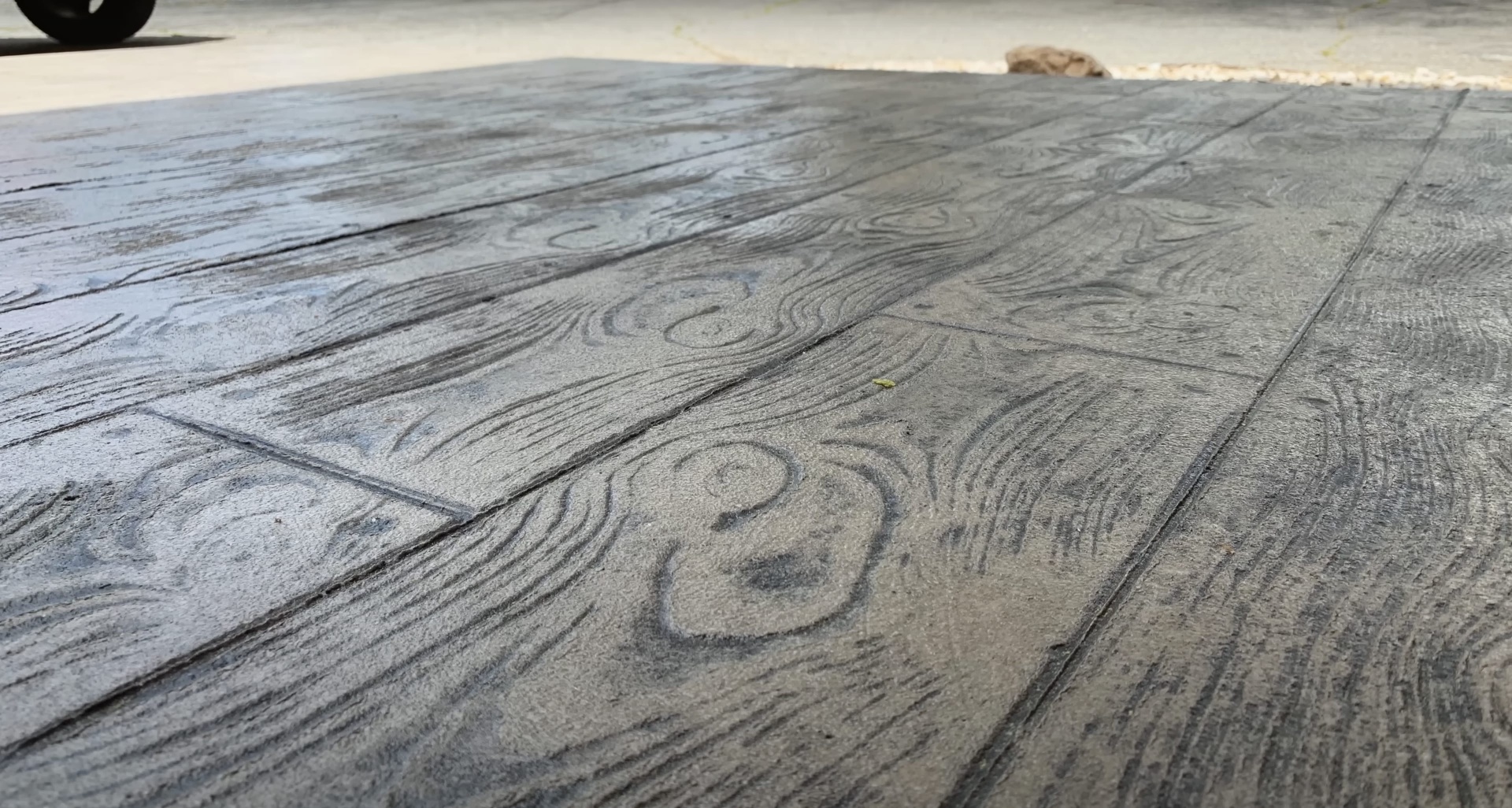 Decorative stamped concrete with wood grain texture pattern
